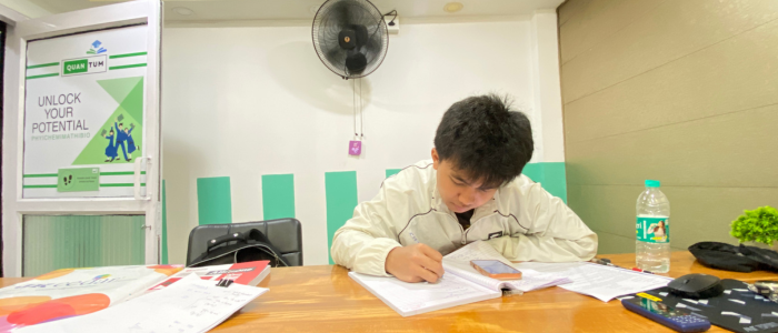 Student studying during a focused PCMB coaching session at Quantum Education in Guwahati.